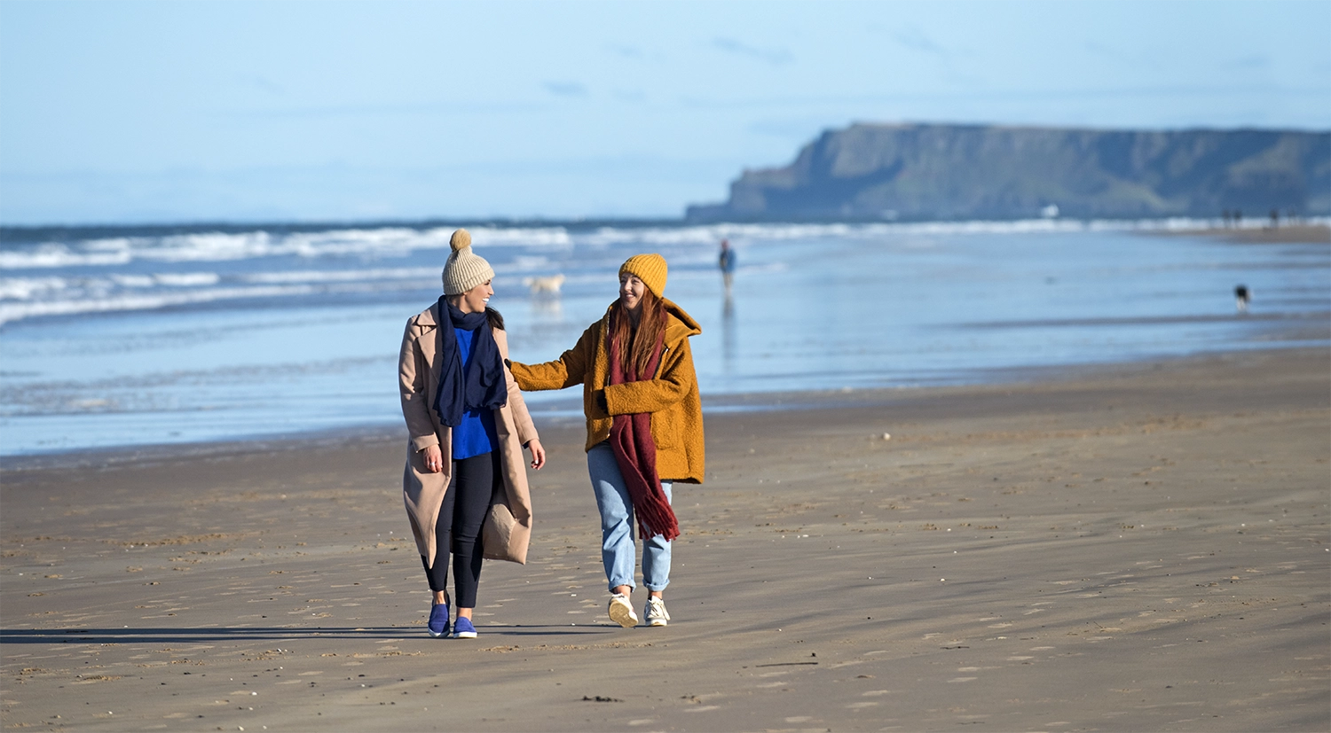 Friends enjoying a walk along the East Strand, Portrush